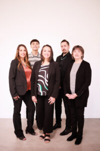 Michele Justice in a staged team photo with a group of people representing a collaborative workplace.